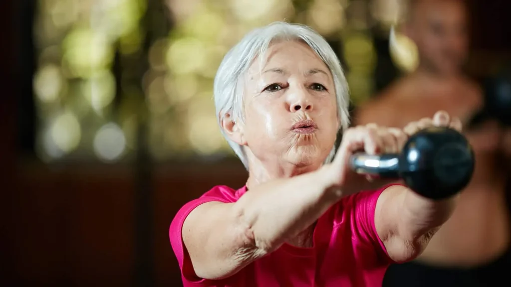 Toning Bingo Wings: Effective Exercises and Tips for Achieving Sleeker Arms 2 Person performing arm exercises with dumbbells West Bromwich