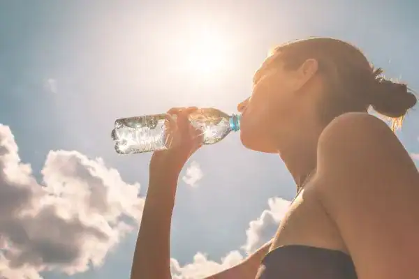 Hydration: The Secret Ingredient for a Toned Stomach and Enhanced Fitness 3 Image of woman drinking water to hydrate West Bromwich after run.