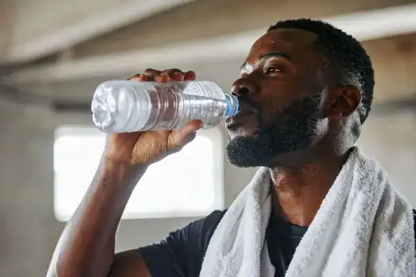 Hydration: The Secret Ingredient for a Toned Stomach and Enhanced Fitness 1 Image of man drinking water to improve hydration West Bromwich after work out.