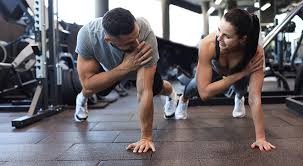 Sculpting Sleek Arms: The Essential Role of Cardio in Toning Without Bulking Up 1 Image of man and woman doing Cardio West Bromwich to tone their arms.
